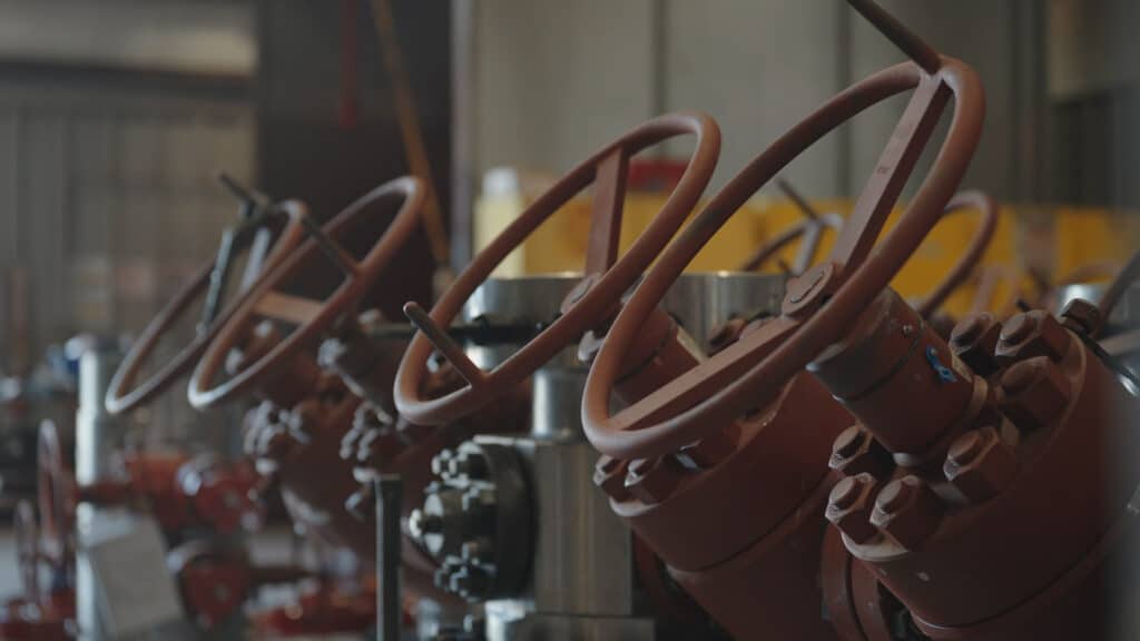 A row of DMLX-S wellhead systems being prepped for delivery by Stream-flo West Texas.